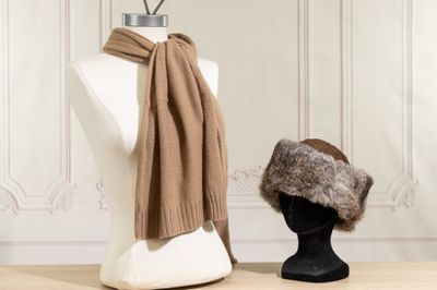 two hats and a scarf on a mannequin head
