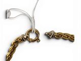 two pieces of jewelry are shown on a white surface