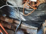 a pile of wood in a room with a tv on it