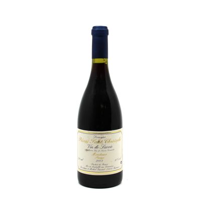 the bottle of wine is sitting on a white surface