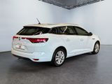 the rear end of a white car in a white room