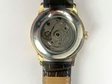 an image of a close up of a wrist watch on a white surface