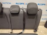 the back seats of a car with a seat belt attached to it