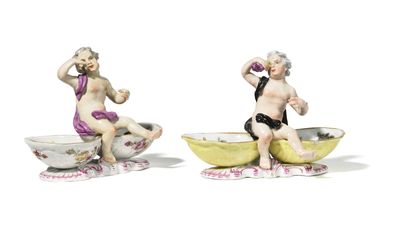 pair of porcelain figurines of a boy and a girl in a bowl