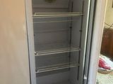 a white refrigerator with a door open in a room