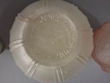 a white plate with a pink object next to it