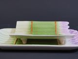 a plate with a cake on it on a black table