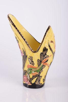 an image of a yellow vase with a bird design on it