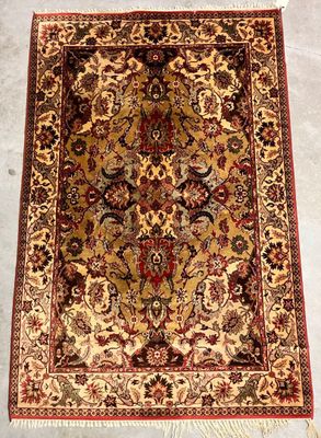 a large oriental rug with a floral design on a beige ground