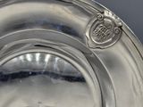 a silver plate that has a crest on it