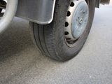 a close up view of a flat tire on a truck