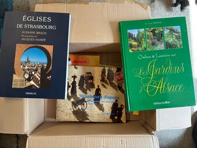 many books that are sitting in a box on the floor