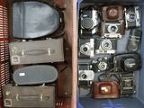 many different types of old cameras in this case