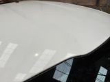 a white car that is parked in a garage