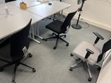 a white table with black chairs in a room