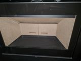 a black oven with a door open on a black counter