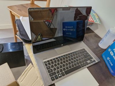a laptop computer sitting on top of a wooden desk