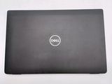 the dell laptop is sitting on a table with its lid open
