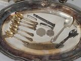 a silver tray with silver spoons and silver spoons on it