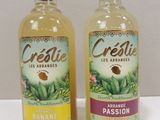 two bottles of creslie are sitting next to each other on a table