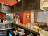 a kitchen with a lot of dishes and glasses on the counter