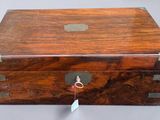 a small wooden box with a tag on it