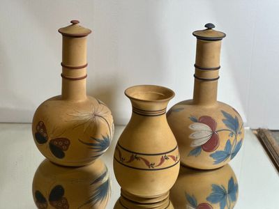 three vases that are sitting on a glass table