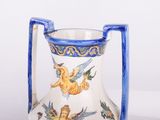 a blue handle on a white vase with a blue handle