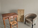 two chairs, a desk, and a chair in a room