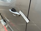a close up of a car door handle with a sticker on it