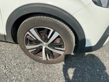 a close up of a tire on a white car
