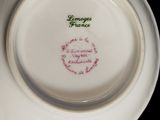 a white plate with a green and red design on it