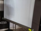 a large projection screen in the corner of a room