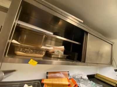 une cuisine équipée d'armoires en inox et d'un évier