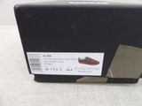 a box with a pair of brown shoes on it