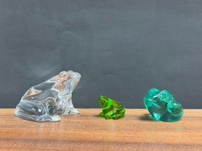 two pieces of glass sitting on a table next to each other