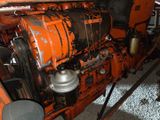 a close up of an orange engine on a truck