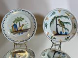 three plates with different designs on them sitting on a table