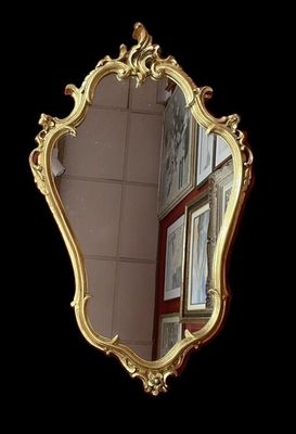 a mirror that is sitting on the wall in front of a window