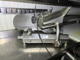 an image of a meat slicer in a commercial kitchen