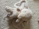 a stuffed animal that is laying down on the floor