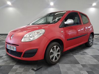 la petite voiture rouge est garée dans le garage sur un sol en damier