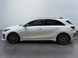 a white car parked in a large room with a white wall