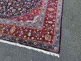 a rug on the ground with a cat sitting on top of it