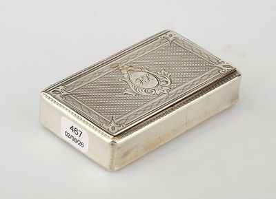 an antique silver cigarette case with a lion emblem on the front