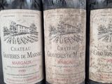 three bottles of wine are lined up in a row on a table