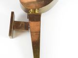 brass wall sconce with a triangular shape on a white background