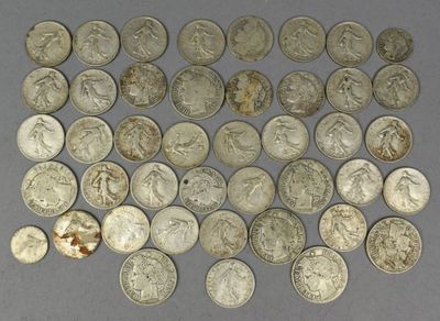 a lot of silver coins that are on the table