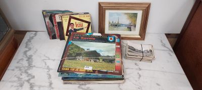 a lot of books on the table next to a picture