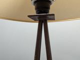 a lamp that is on top of a wooden stand
